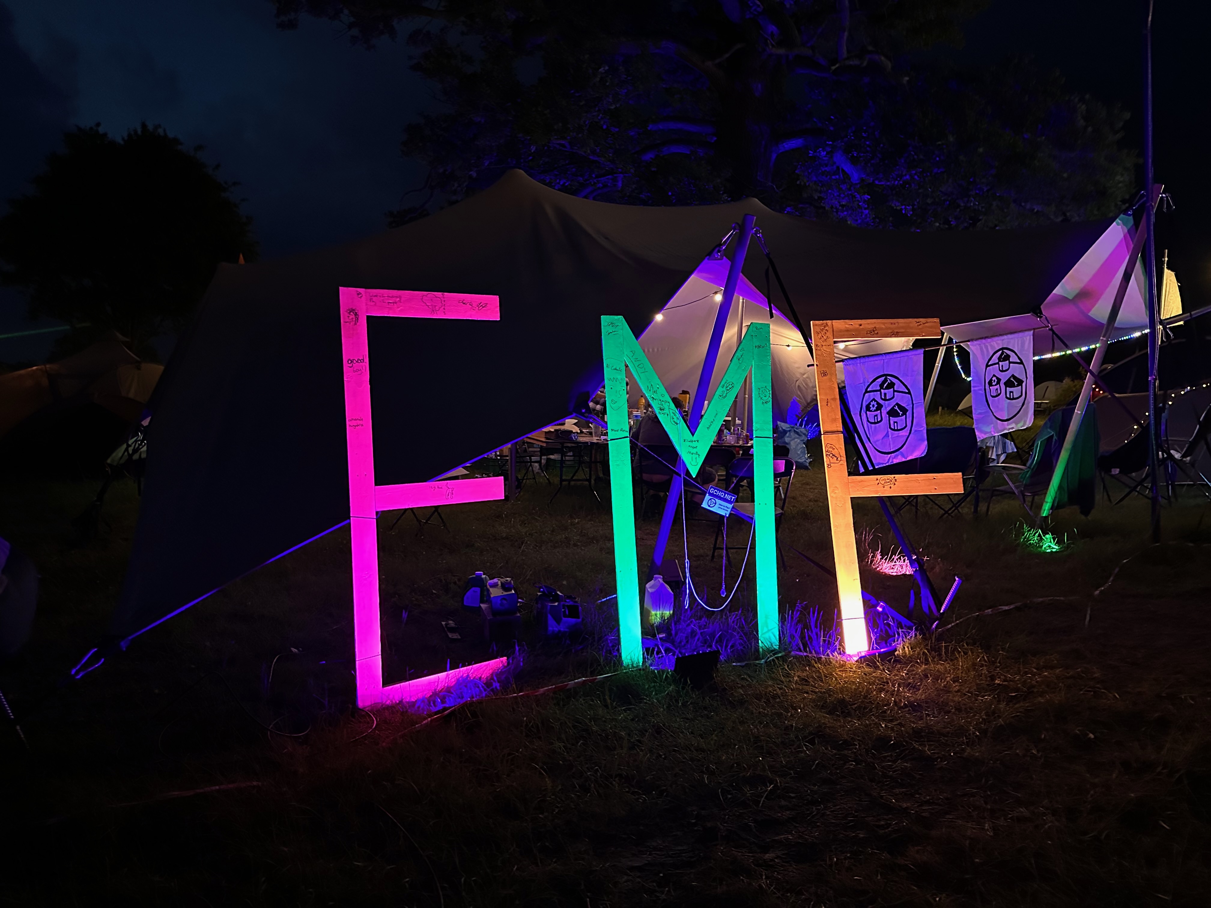 Night time photo of a neon sign that says EMF.