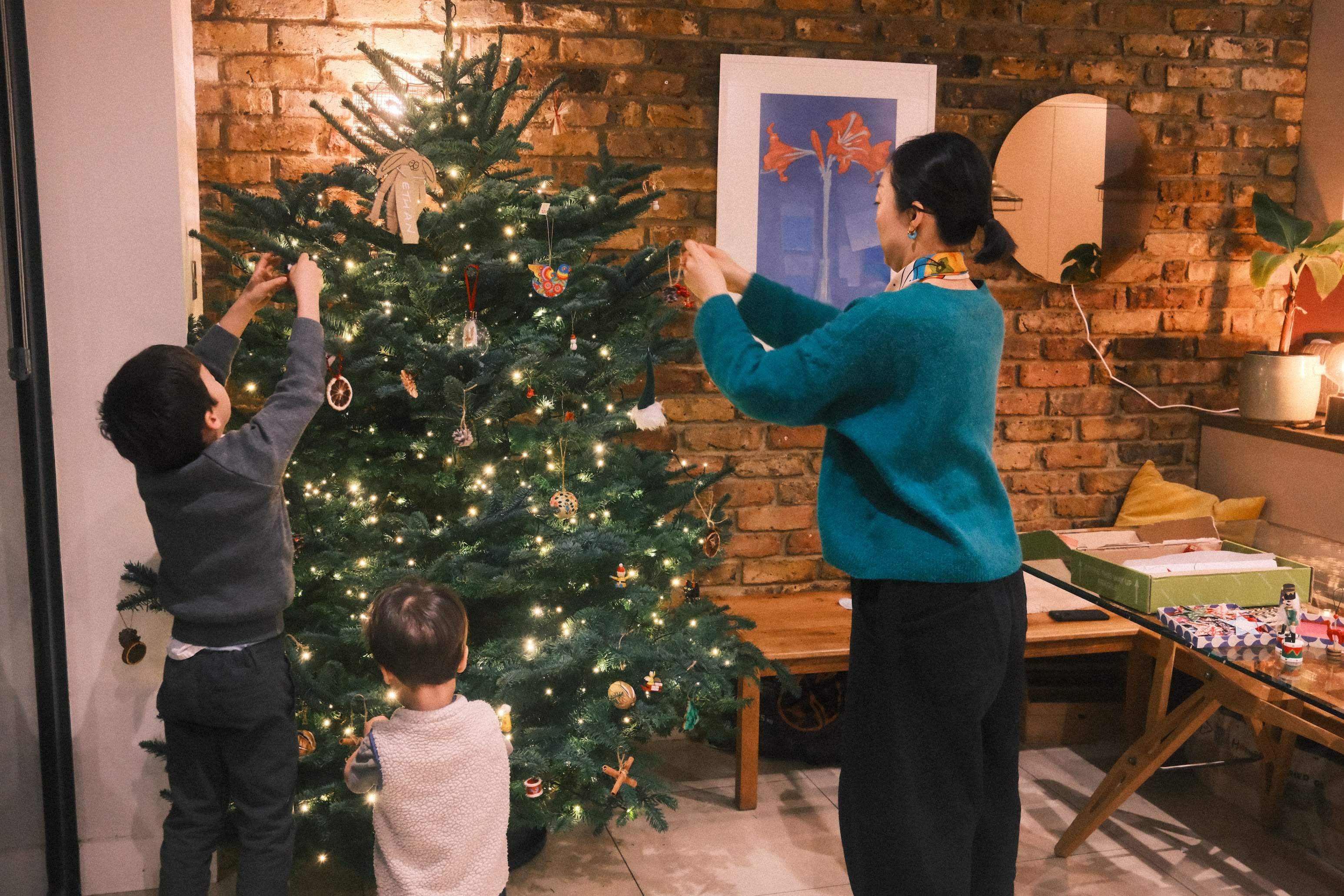 Family decorating a christmas tree