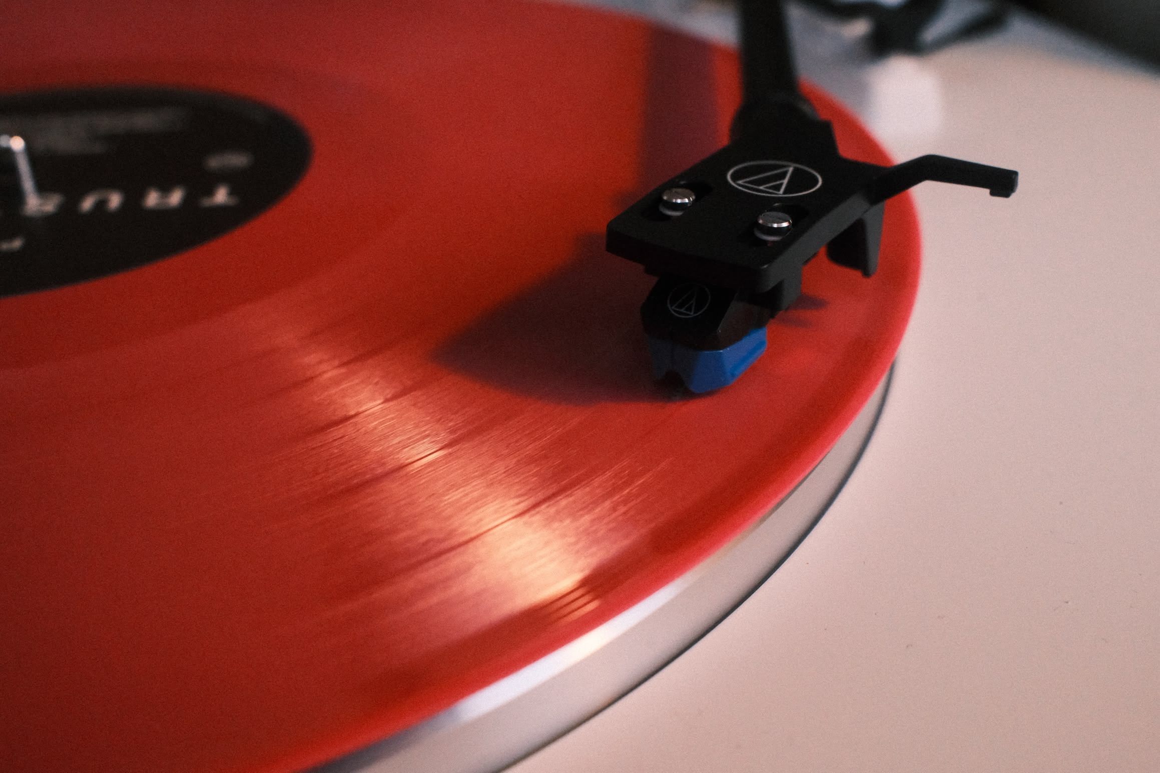 A close-up of a record player. The stylus rests on the record.