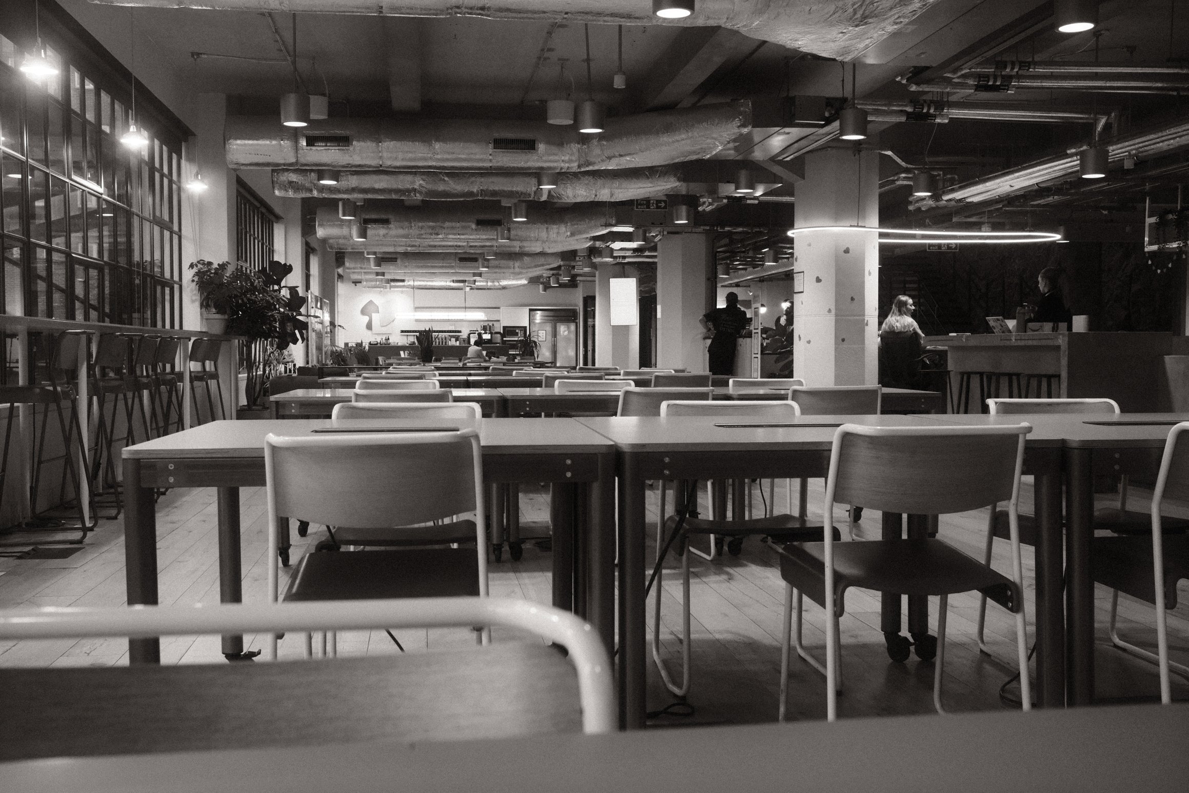 A black and white photo of a hand on a keyboard, the thumb playing the note D.