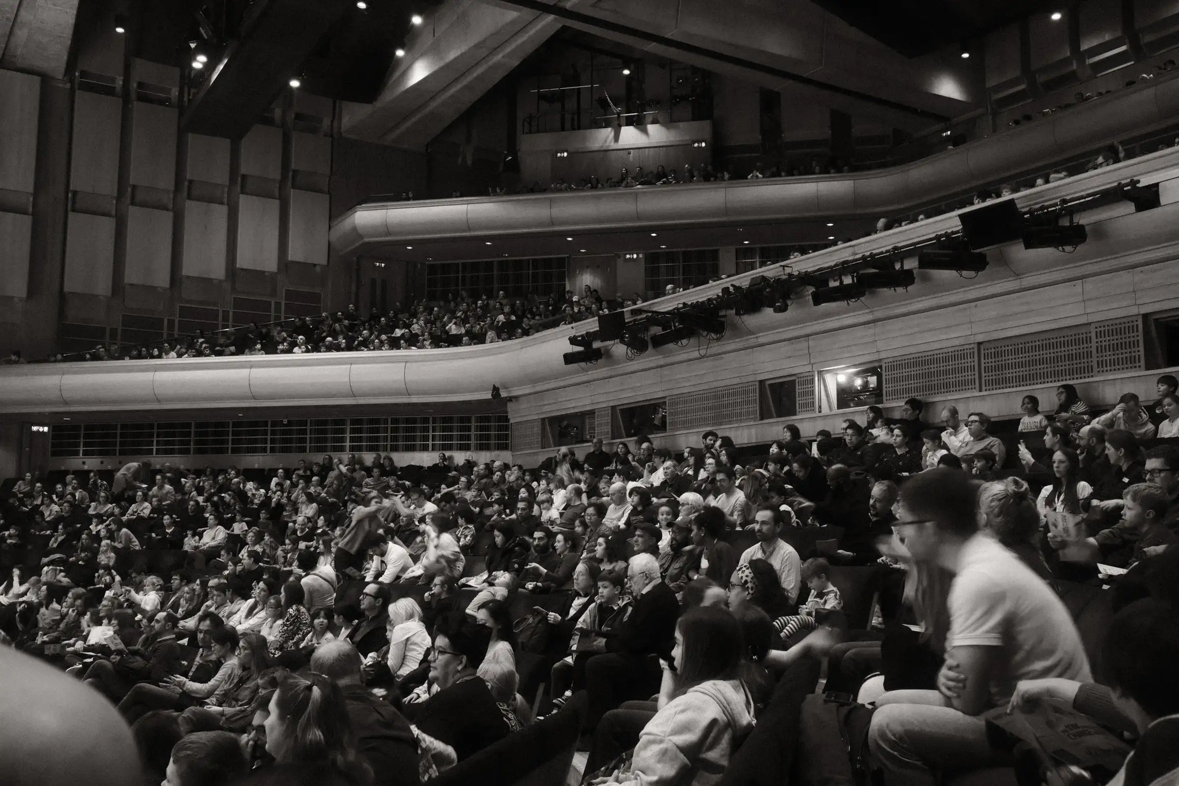 A black and white photo of the audience in the Barbican Concert Hall.