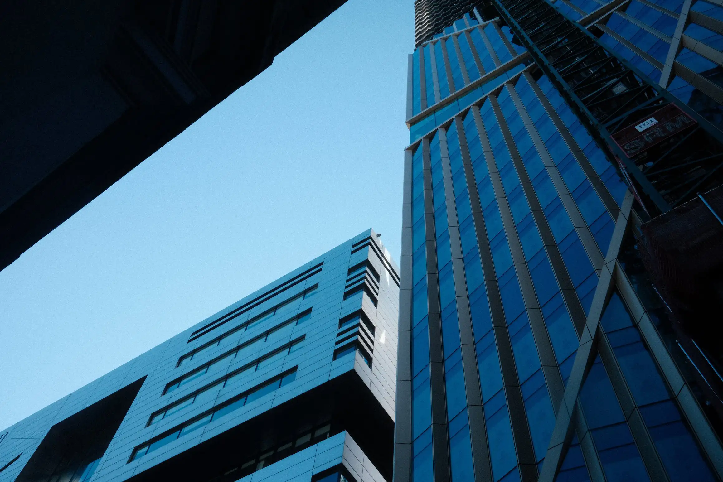 a photo looking up between tall buildings