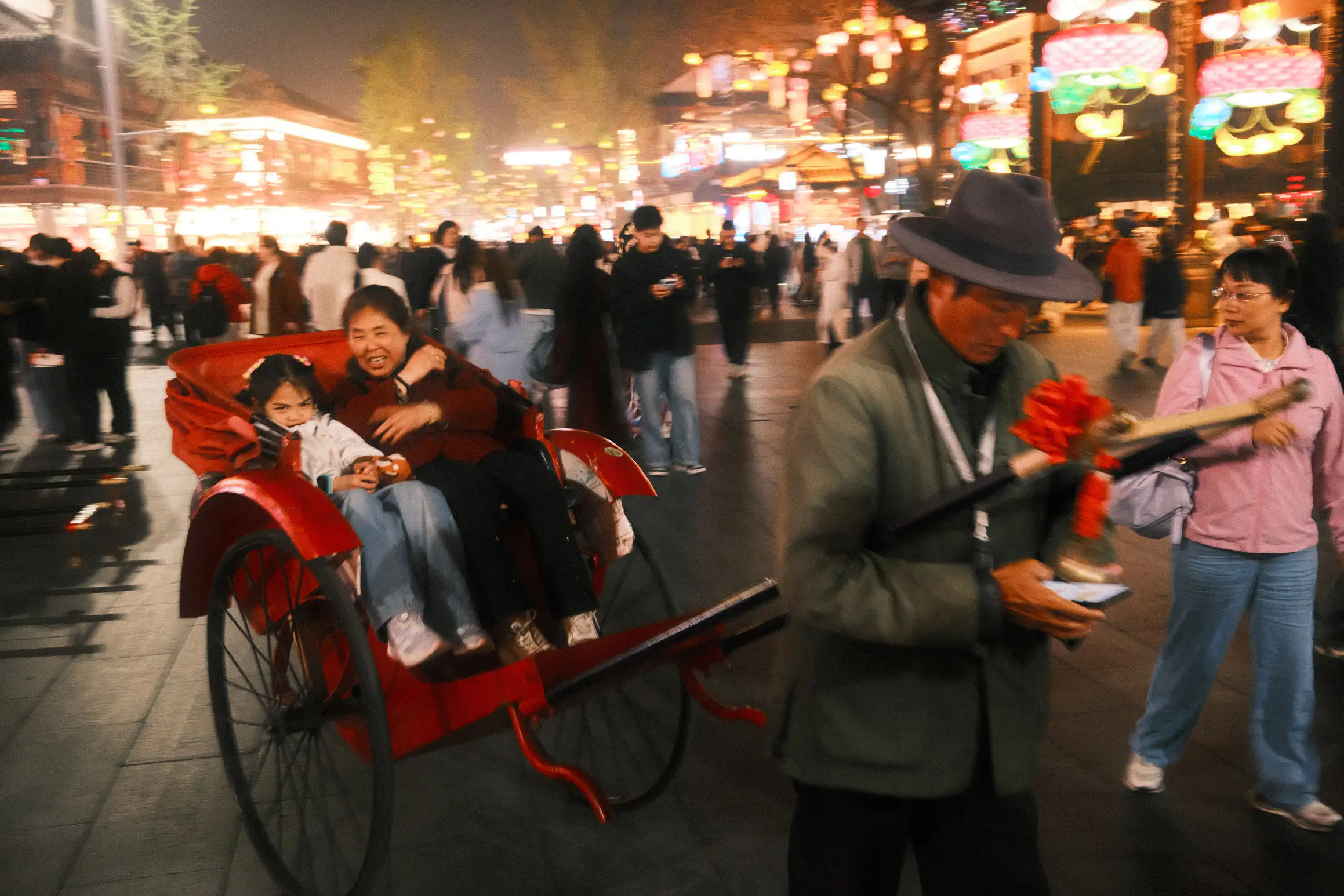 a lady and child settle in for a rickshaw ride