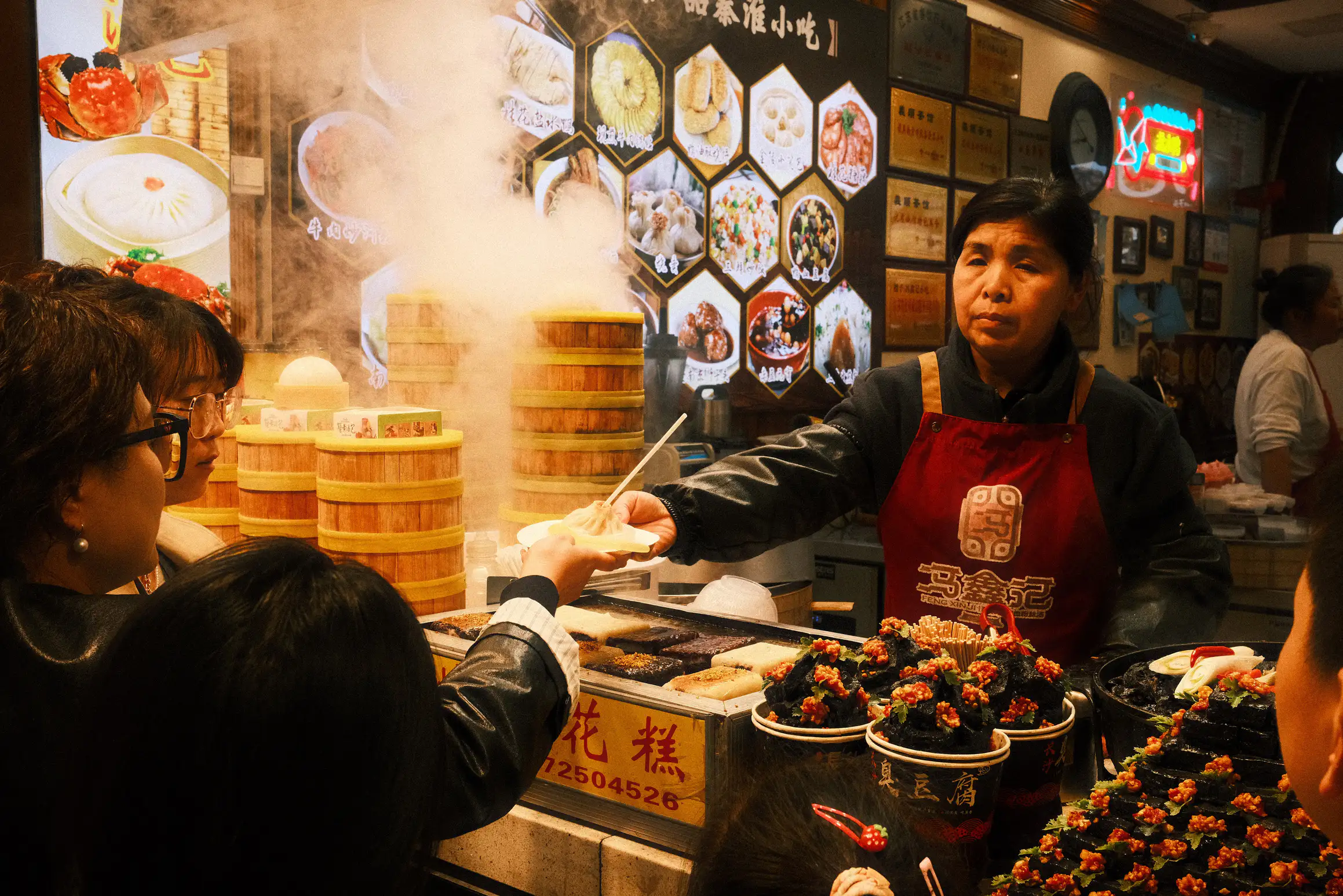 a night market stall serving large soup dumplings