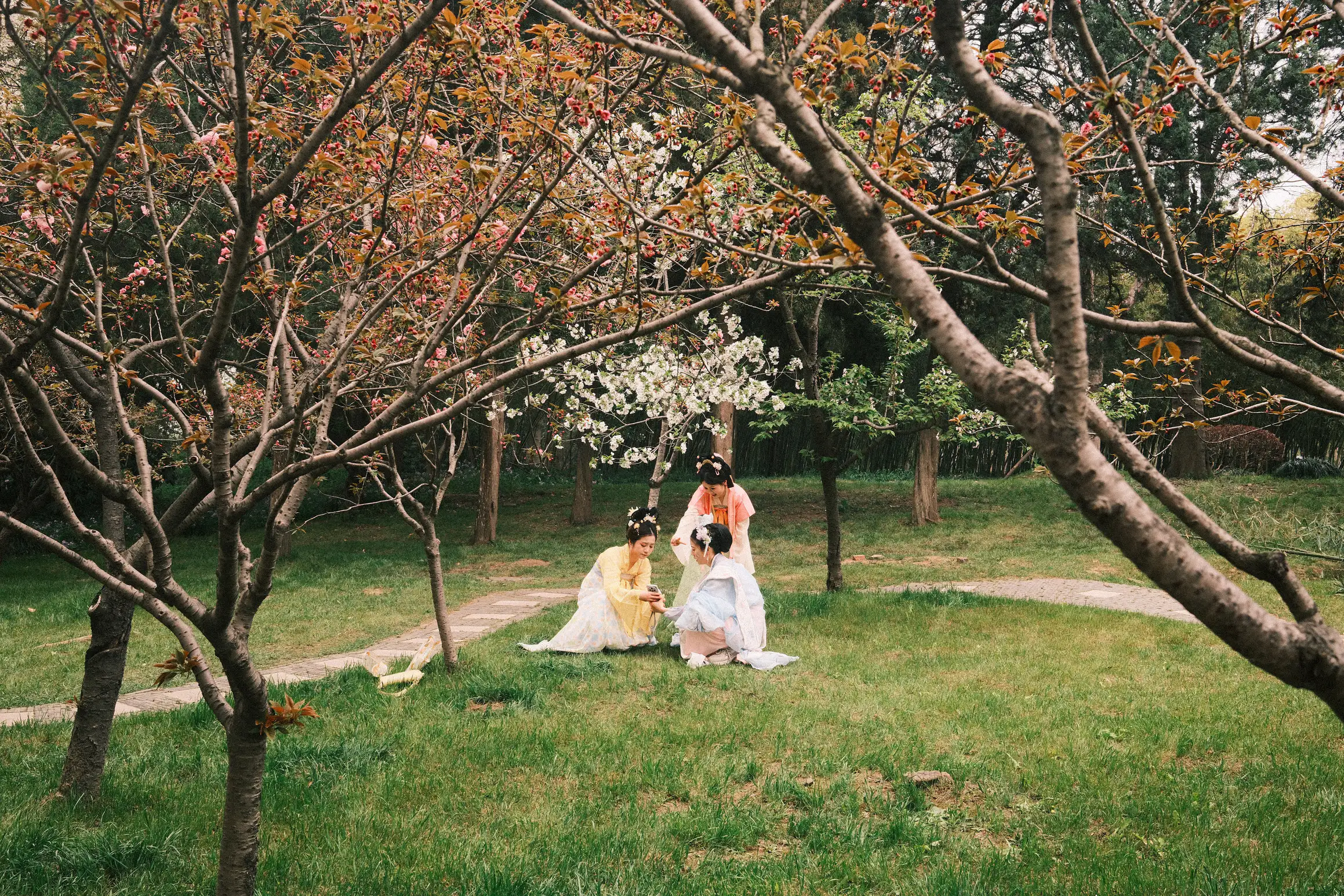 away from the crowds, three people dress in traditional costume for social media