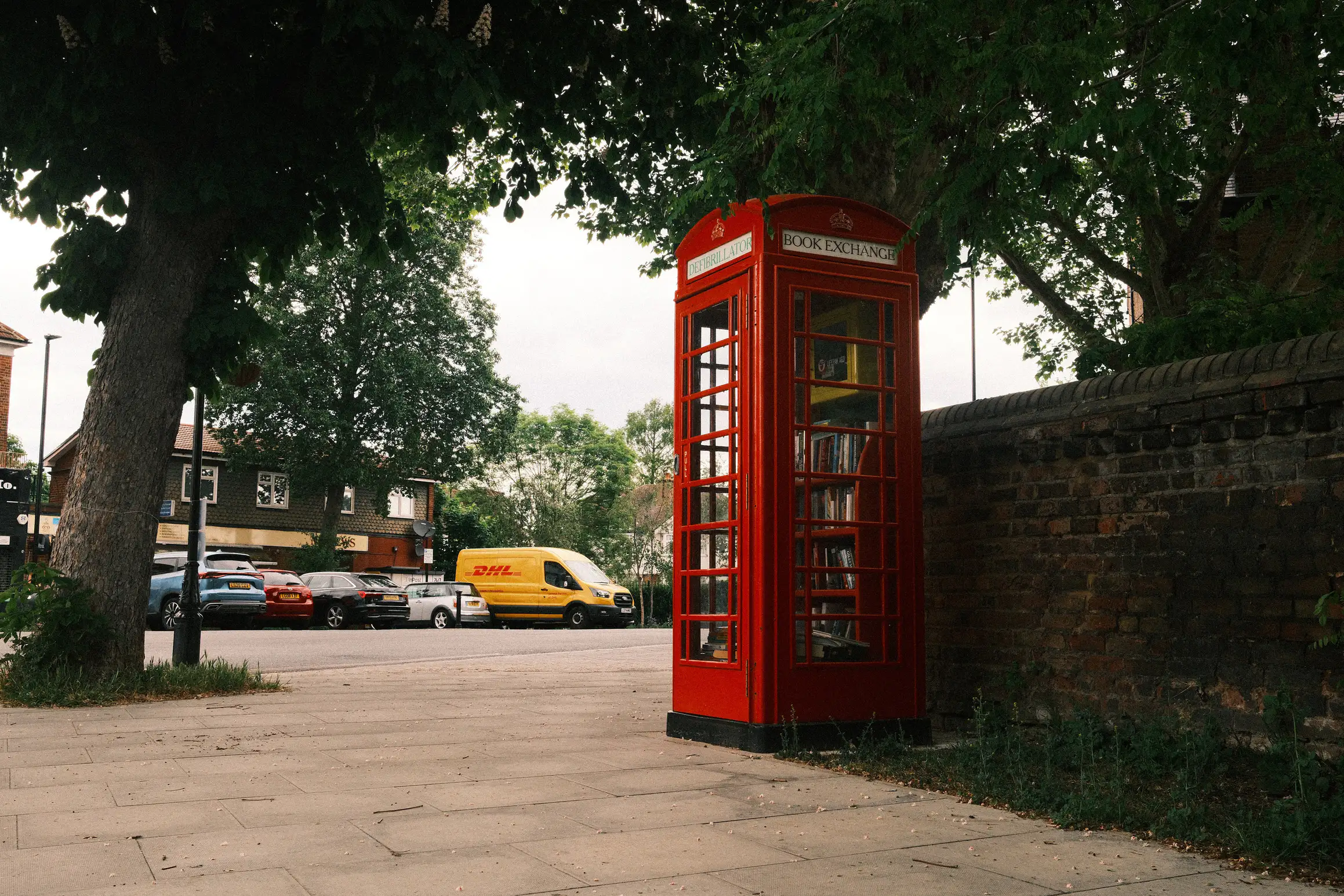 a picture of a red phone box, the phone has been replaced by shelves of books