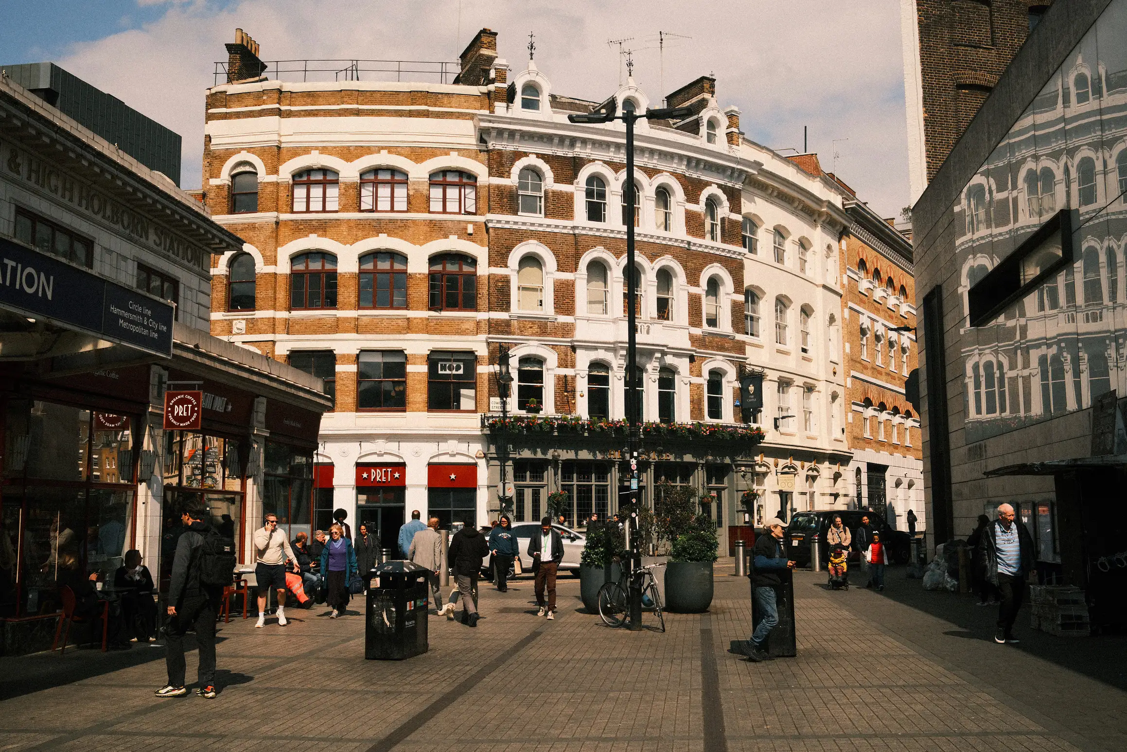 a photograph looking past the two main entrances to Farringdon station in London