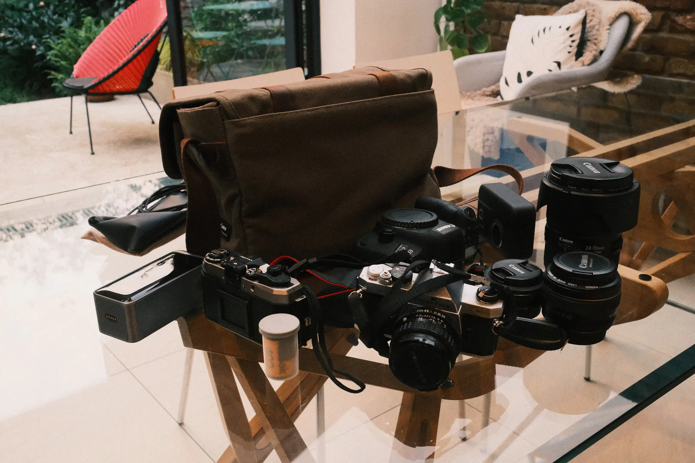 a collection of camera gear on a glass table