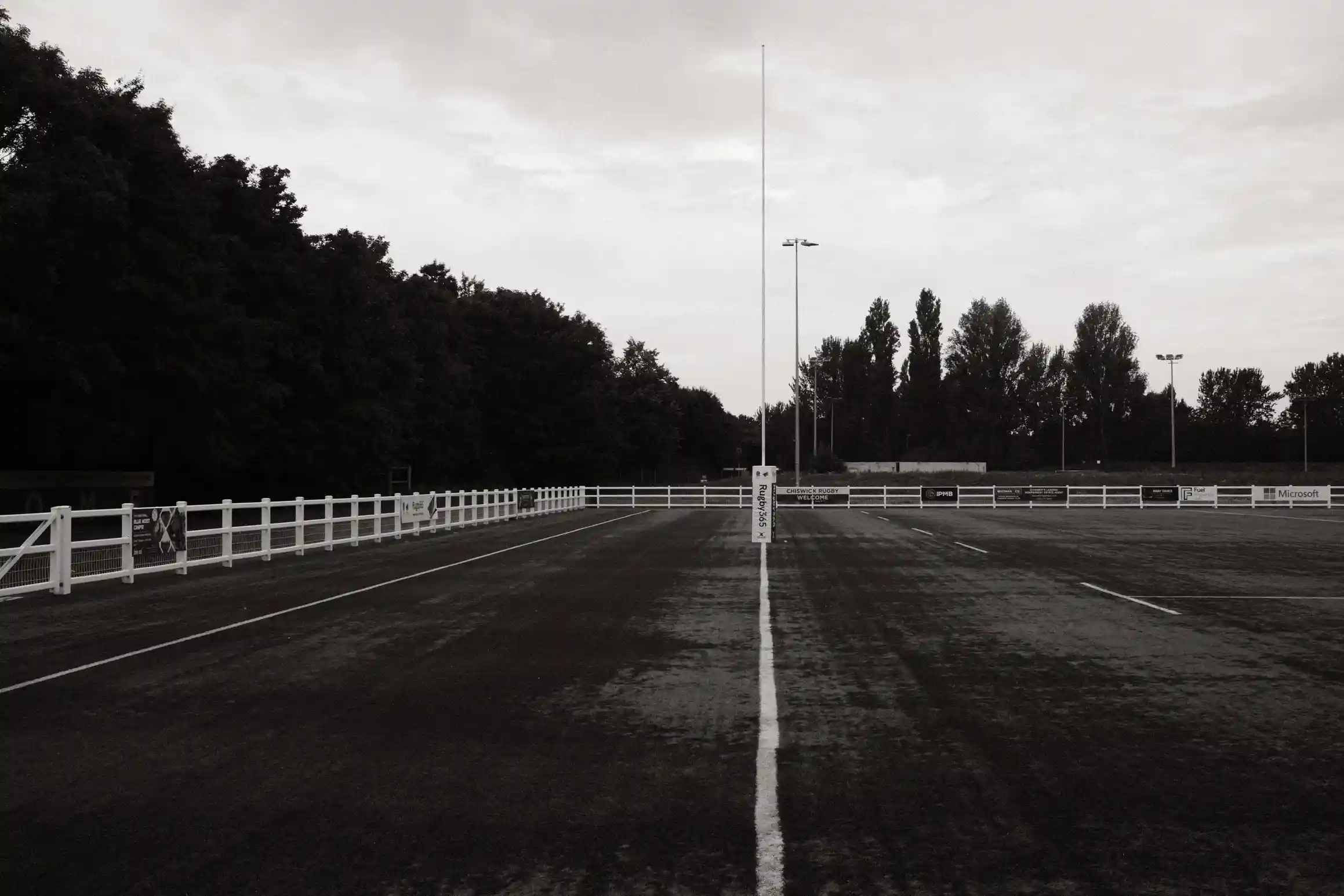 A black and white photo looking along the try-line of a rugby pitch