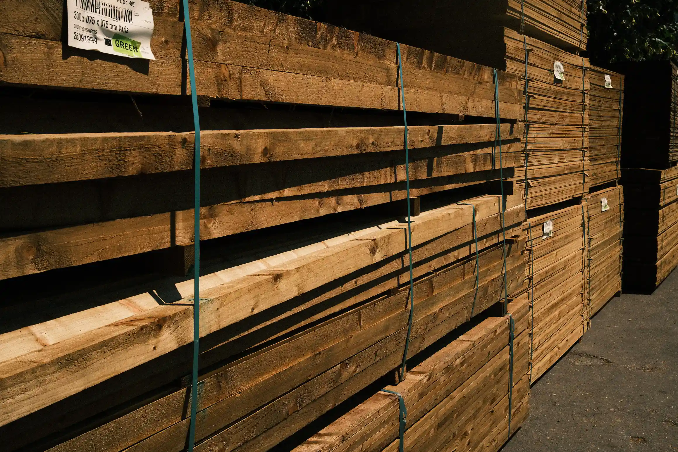 A photo of stacks of wood tied up in bundles in a timber yard.